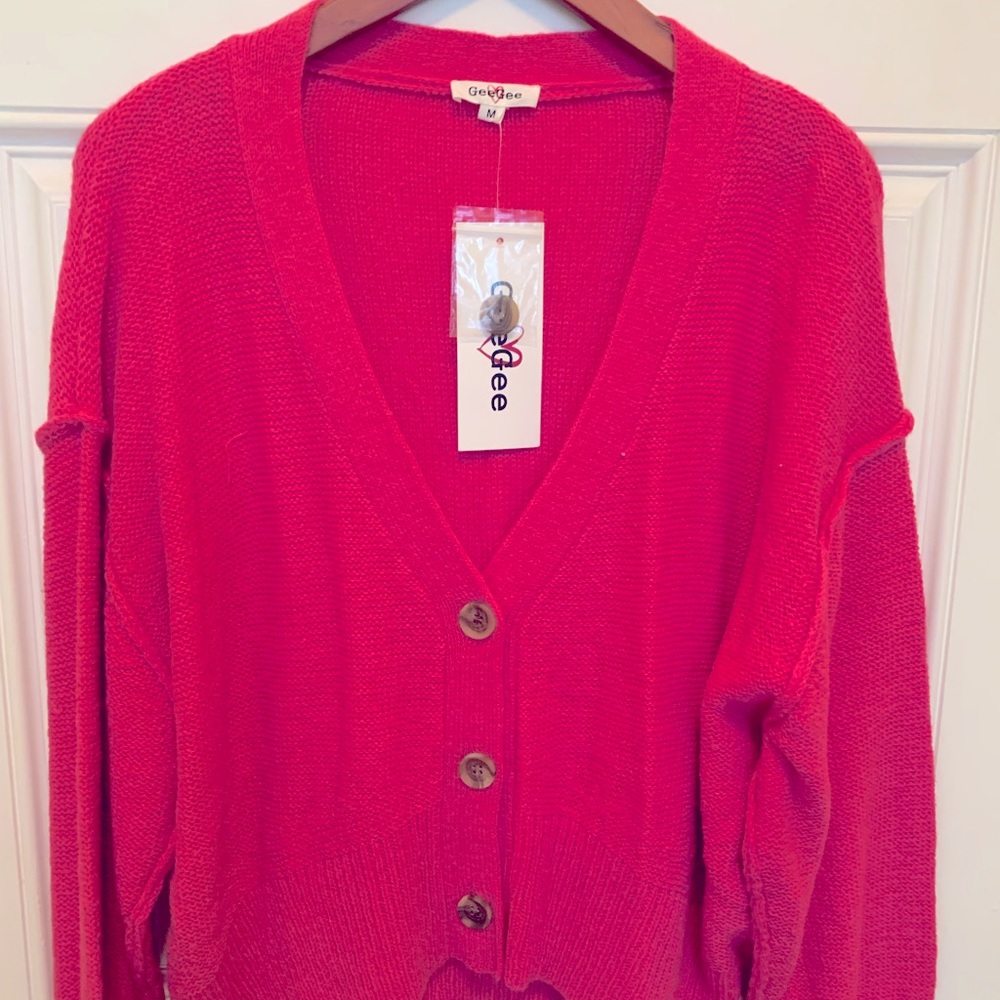 Bright pink cardigan.